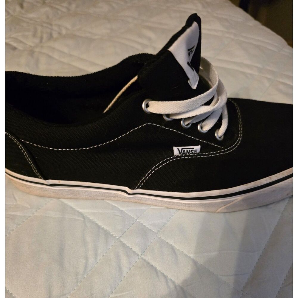 These are black Vans Authentic sneakers with white laces. - Picture 9 of 9
